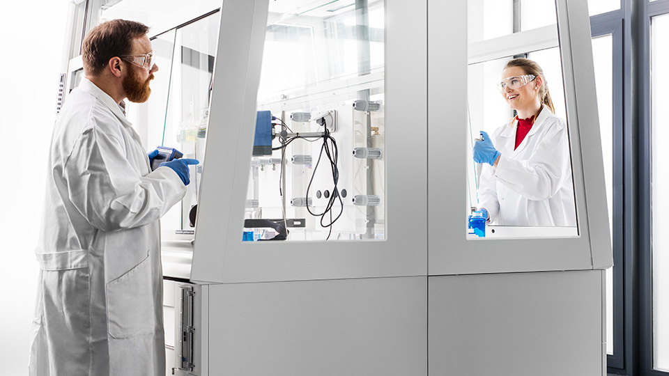 Two people standing in a laboratory